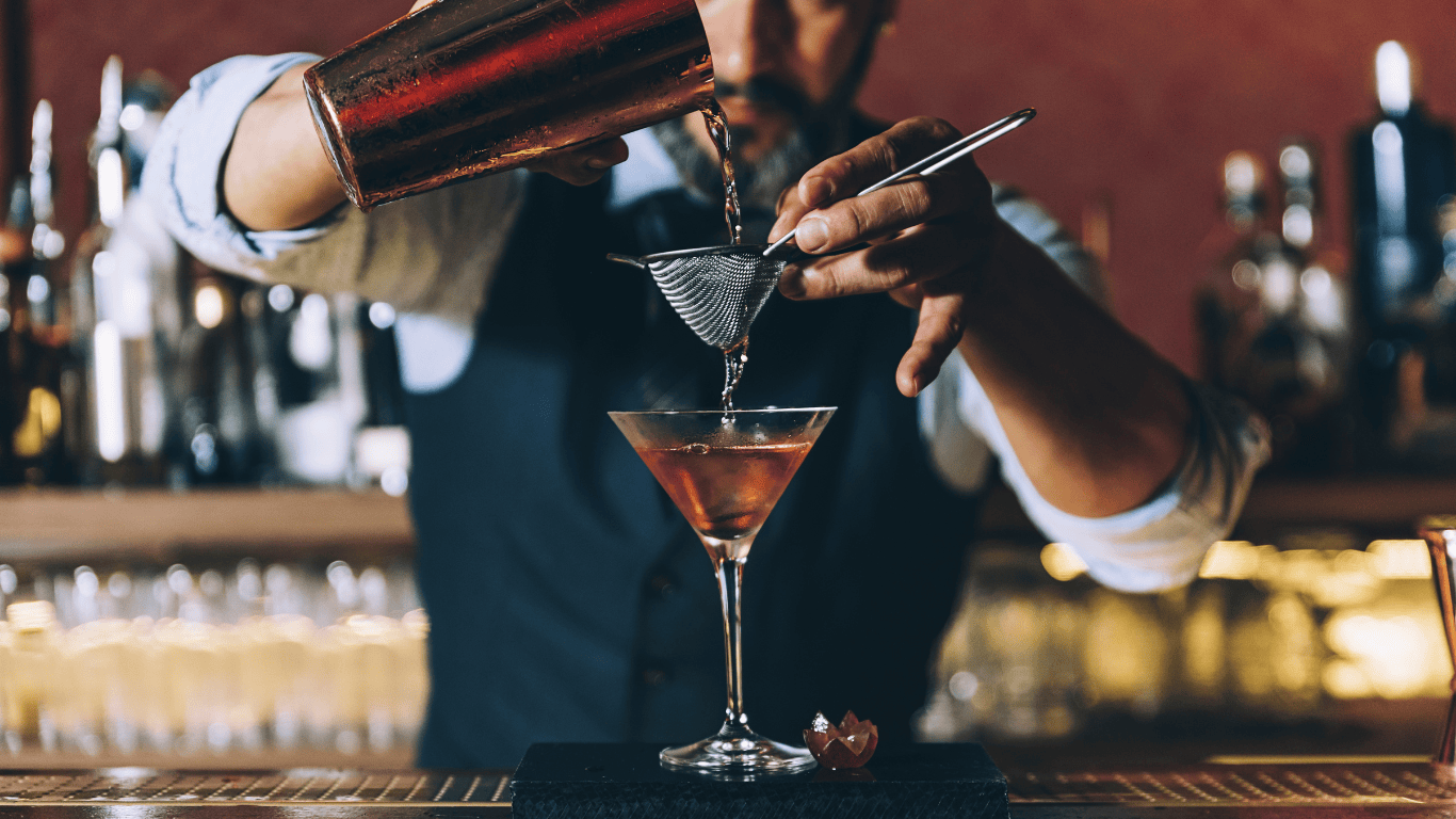 A bartender making a cocktail.